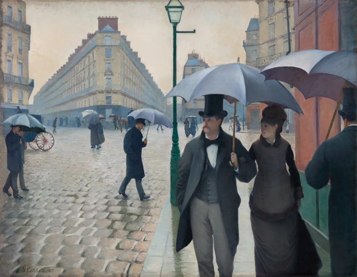Caillebotte painting of umbrella-carrying pedestrians crossing a broad gray Paris intersection on a rainy day.